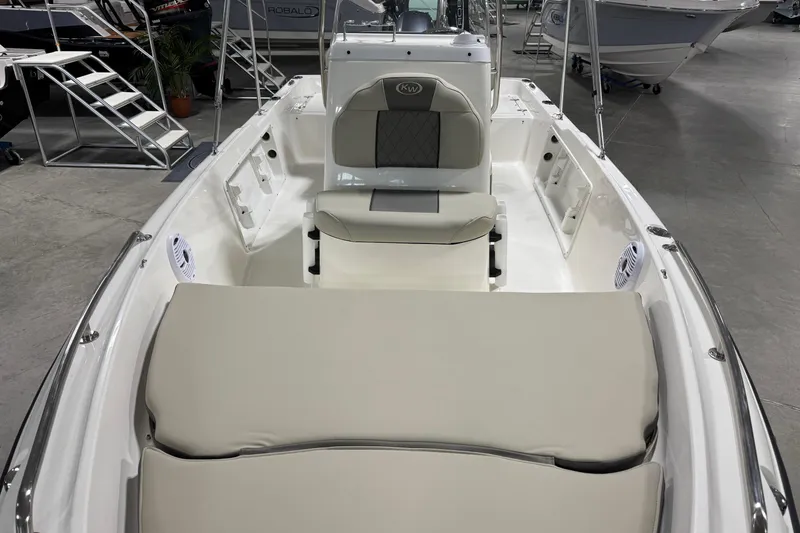 Slide: The Image of 2026 Key West 1720 Center Console boat interior with cushioned seating in showroom. - 7
