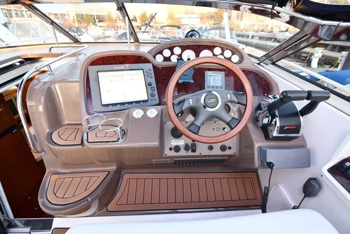 Slide: The Image of 2006 Regal Commodore 3560 boat dashboard with steering wheel, navigation system, and control panel. - 10