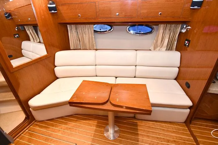 Slide: The Image of Luxurious interior of 2006 Regal Commodore 3560 yacht with plush seating and wooden table. - 12