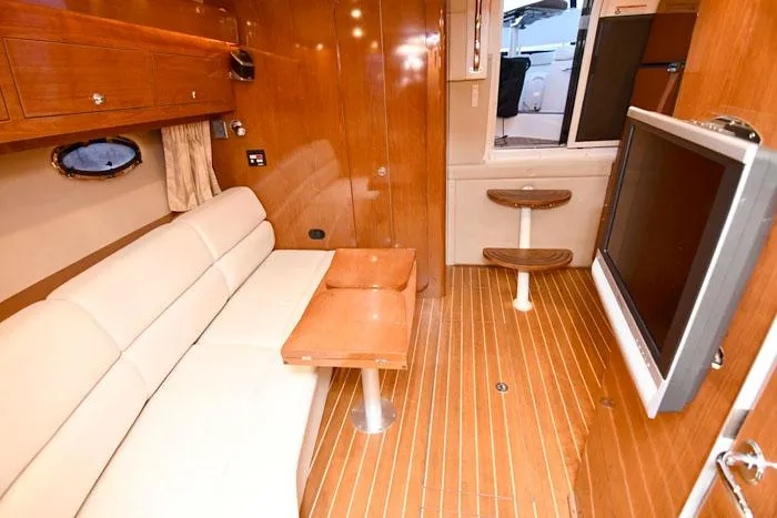 Slide: The Image of Luxurious interior of 2006 Regal Commodore 3560 yacht with sofa and TV. - 14