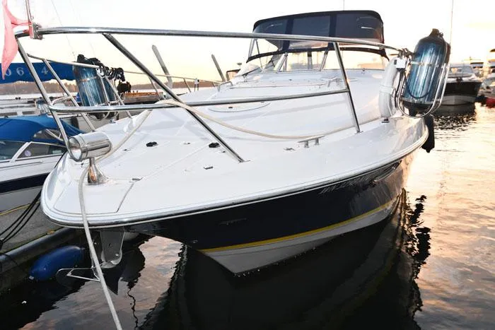 Slide: The Image of 2006 Regal Commodore 3560 yacht docked at sunset, showcasing sleek design and modern features. - 2