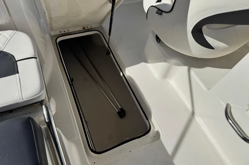 Slide: The Image of 2022 Bayliner VR6 Bowrider OB interior storage compartment with seating and handle. - 15