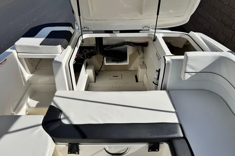 Slide: The Image of 2022 Bayliner VR6 Bowrider OB interior with open storage compartments and seating. - 19