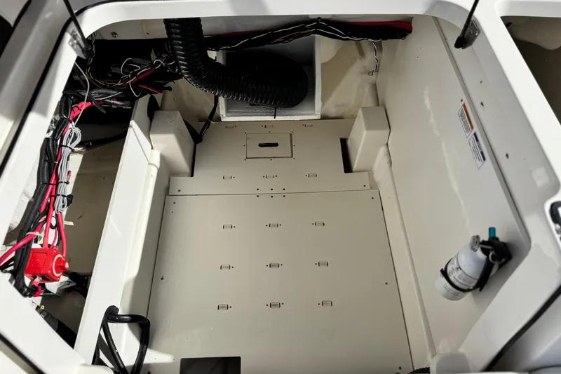 Slide: The Image of 2022 Bayliner VR6 Bowrider OB engine compartment with wiring and components visible. - 20