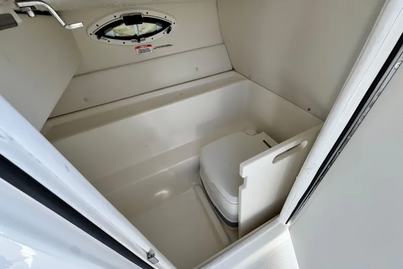 Slide: The Image of 2022 Bayliner VR6 Bowrider OB interior with compact marine toilet. - 22