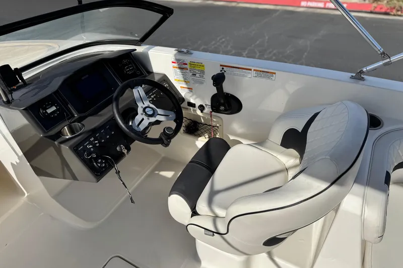 Slide: The Image of 2022 Bayliner VR6 Bowrider OB cockpit with steering wheel and comfortable seating. - 23