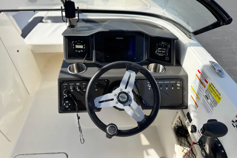 Slide: The Image of 2022 Bayliner VR6 Bowrider OB dashboard with steering wheel and control panel. - 24