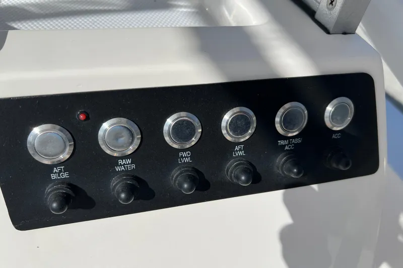 Slide: The Image of Control panel of 2024 Robalo 206 Cayman boat with labeled switches. - 16