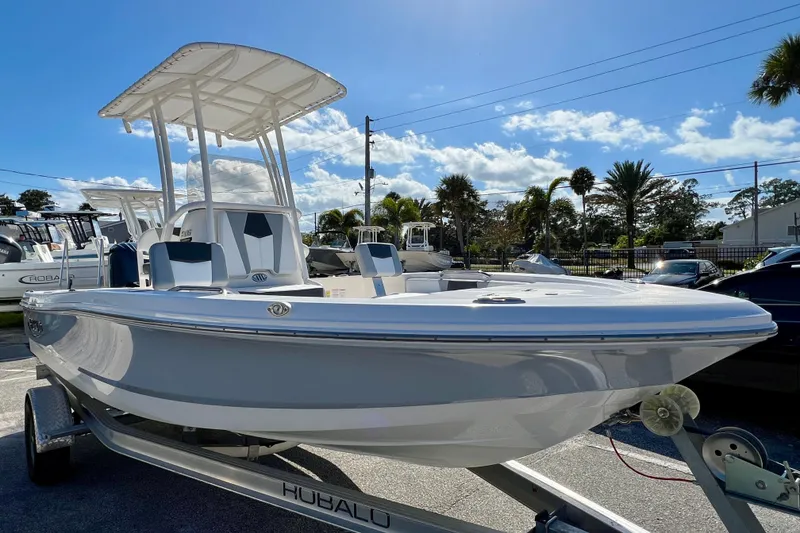 Slide: The Image of 2024 Robalo 206 Cayman boat on trailer under clear blue sky. - 3