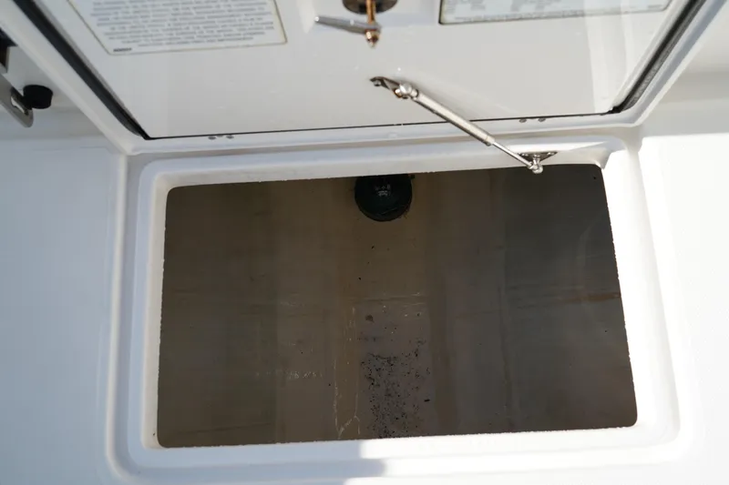 Slide: The Image of Open storage compartment on 2021 Edgewater 320CC boat. - 10