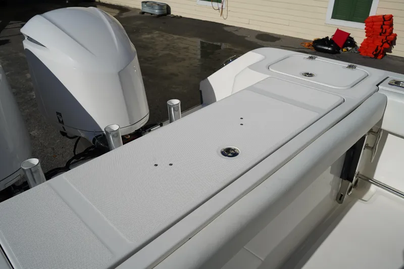 Slide: The Image of 2021 Edgewater 320CC boat with dual outboard engines and spacious deck layout. - 11
