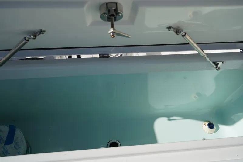 Slide: The Image of Open storage compartment on 2021 Edgewater 320CC boat, showing interior details. - 12