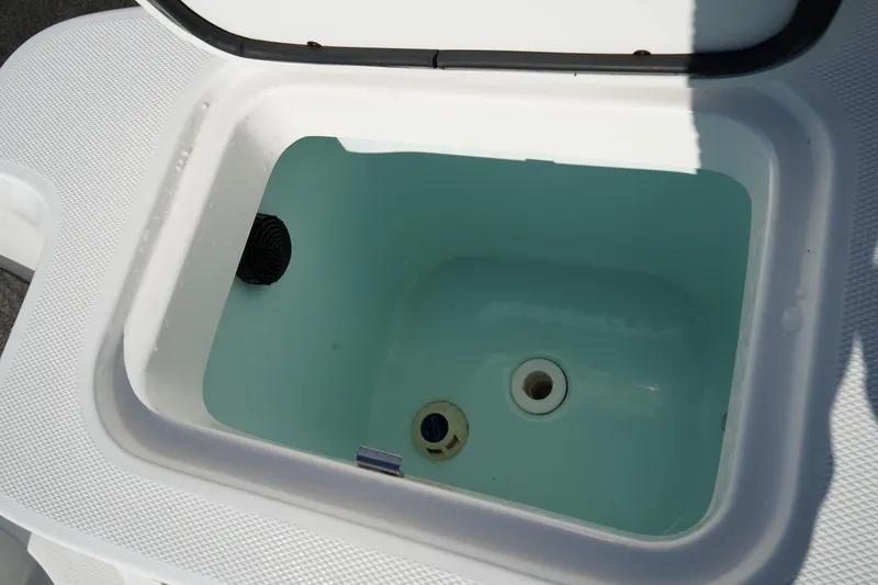 Slide: The Image of Livewell compartment on a 2021 Edgewater 320CC boat, open and empty. - 14