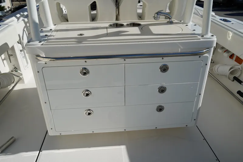 Slide: The Image of Edgewater 320CC 2021 boat interior with storage drawers and sink. - 17