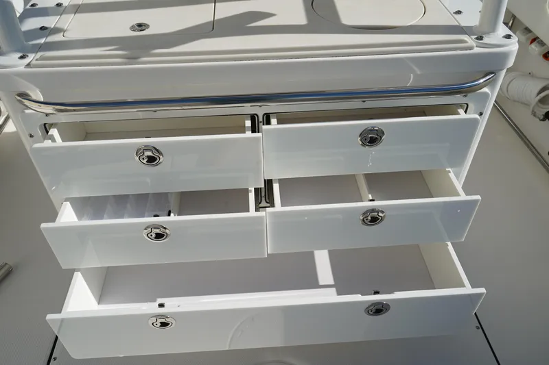 Slide: The Image of Open storage drawers on a 2021 Edgewater 320CC boat, showcasing sleek design and functionality. - 18