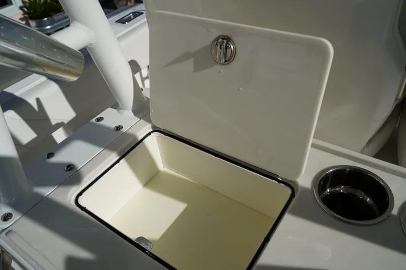 Slide: The Image of Open storage compartment on 2021 Edgewater 320CC boat with cup holder. - 19