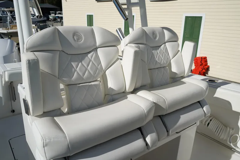 Slide: The Image of Luxurious white seating on 2021 Edgewater 320CC boat, featuring diamond stitching. - 24