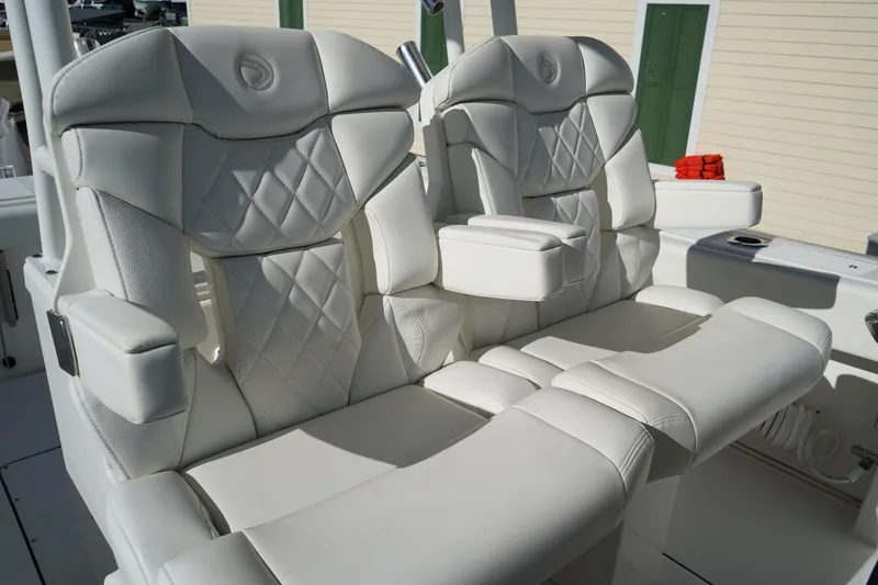 Slide: The Image of Luxurious white leather seats on a 2021 Edgewater 320CC boat. - 25