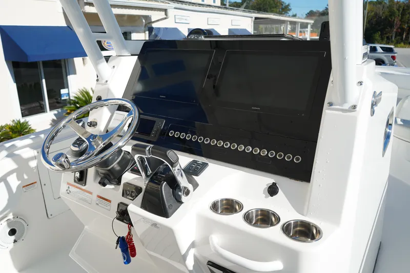Slide: The Image of Edgewater 320CC 2021 boat dashboard with steering wheel and control panel. - 27