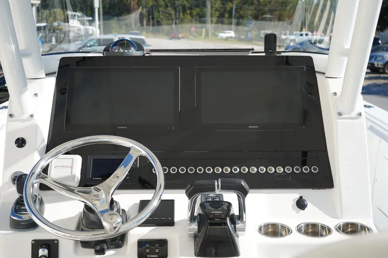 Slide: The Image of Edgewater 320CC 2021 boat dashboard with Garmin displays and Yamaha controls. - 28