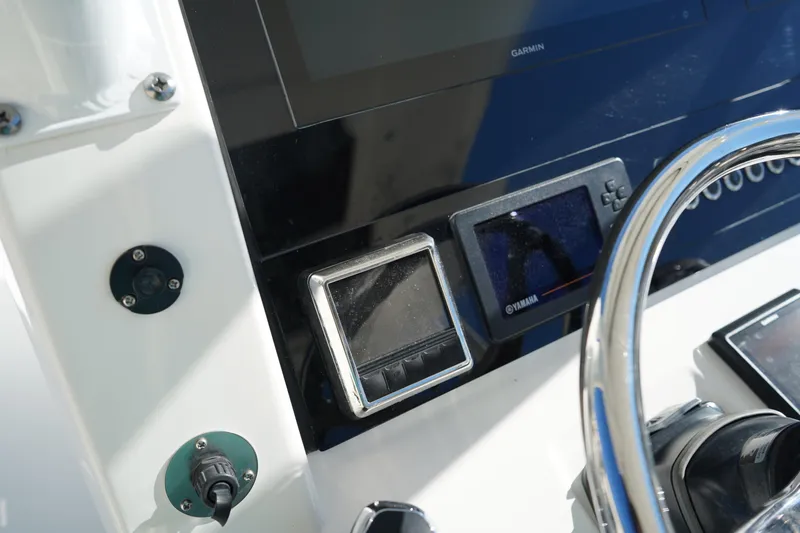 Slide: The Image of Edgewater 320CC 2021 boat dashboard with Garmin and Yamaha displays. - 30