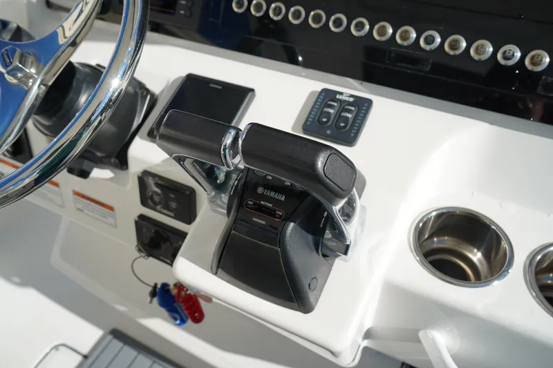 Slide: The Image of Edgewater 320CC 2021 boat console with Yamaha controls and steering wheel. - 32