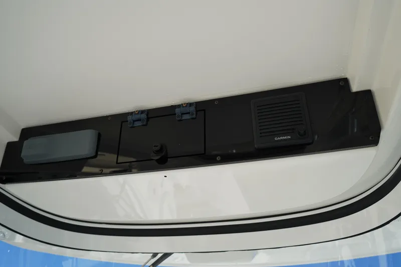 Slide: The Image of 2021 Edgewater 320CC boat console with Garmin speaker and storage compartments. - 33