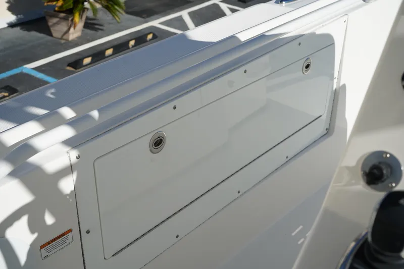 Slide: The Image of Edgewater 320CC 2021 boat storage compartment with sleek white finish. - 35