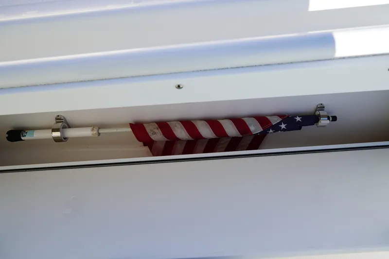 Slide: The Image of American flag stored in a compartment on a 2021 Edgewater 320CC boat. - 37