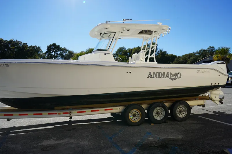 Slide: The Image of 2021 Edgewater 320CC boat on trailer, side view, outdoors. - 4