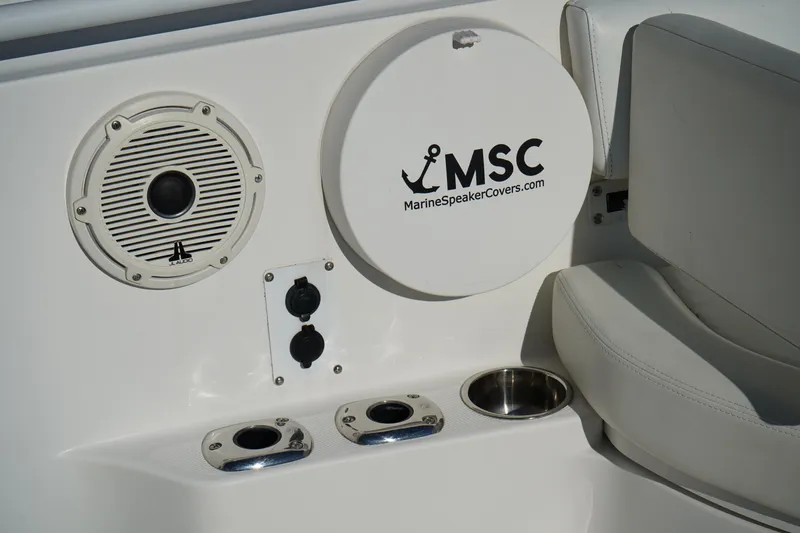 Slide: The Image of Edgewater 320CC 2021 boat interior with marine speaker and cup holders. - 46