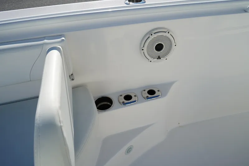 Slide: The Image of Edgewater 320CC 2021 boat interior with speaker and cup holders. - 47