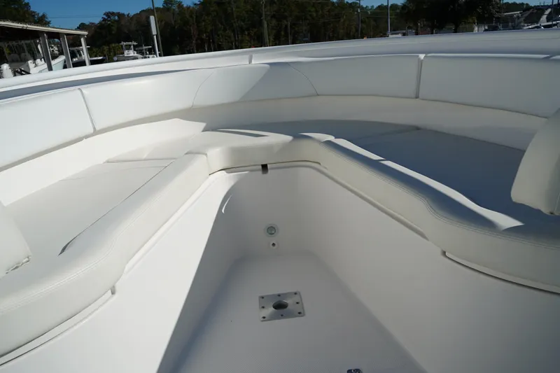 Slide: The Image of 2021 Edgewater 320CC boat interior with white cushioned seating and spacious layout. - 50