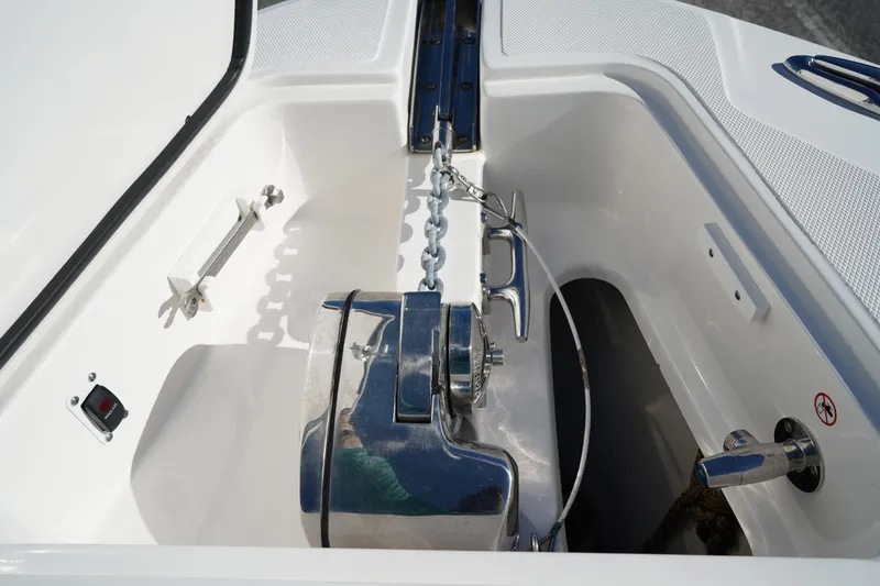 Slide: The Image of Anchor compartment of 2021 Edgewater 320CC boat with chain and winch system. - 52
