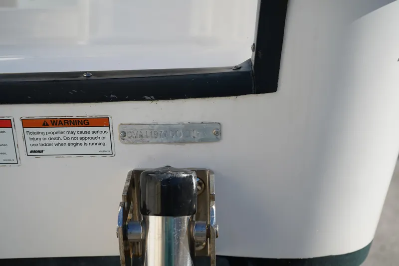 Slide: The Image of 2021 Edgewater 320CC boat stern with warning labels and identification plate. - 53