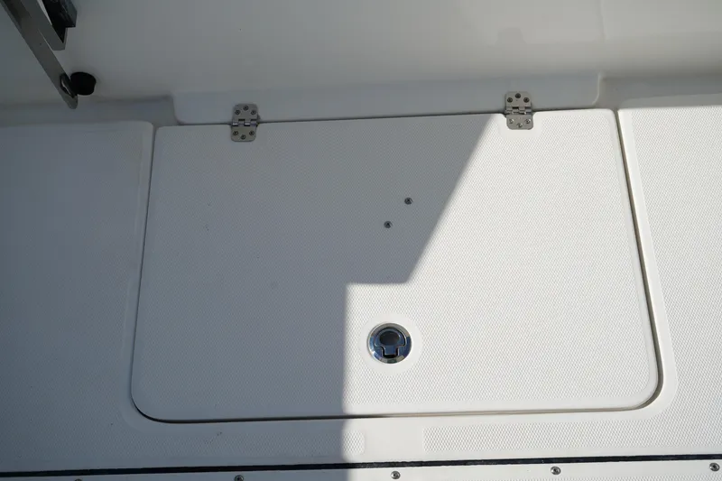 Slide: The Image of Hatch cover on 2021 Edgewater 320CC boat, featuring stainless steel hinges. - 9