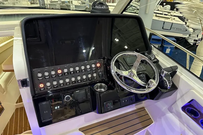 Slide: The Image of 2026 Grady-White Express 340 helm with modern controls and sleek steering wheel. - 10