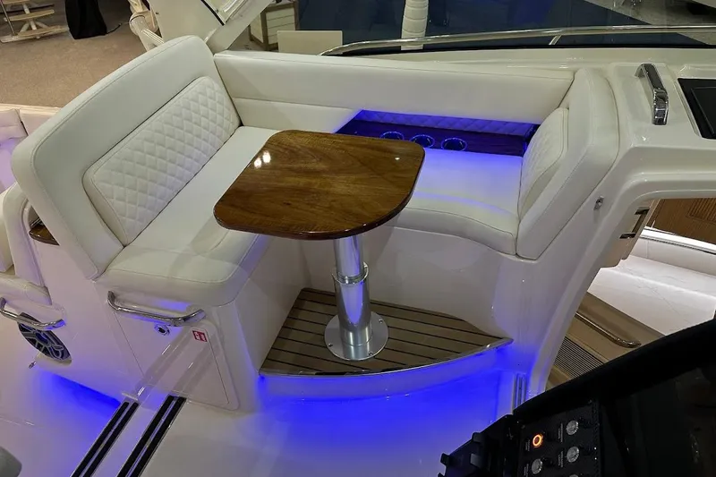 Slide: The Image of Luxurious seating area on 2026 Grady-White Express 340 boat with ambient blue lighting. - 15