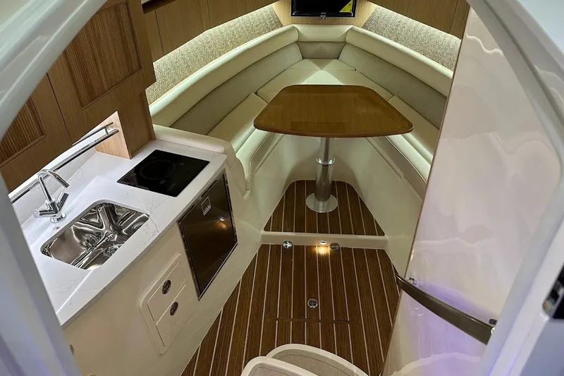 Slide: The Image of Luxurious interior of 2026 Grady-White Express 340 boat with kitchenette and seating area. - 19