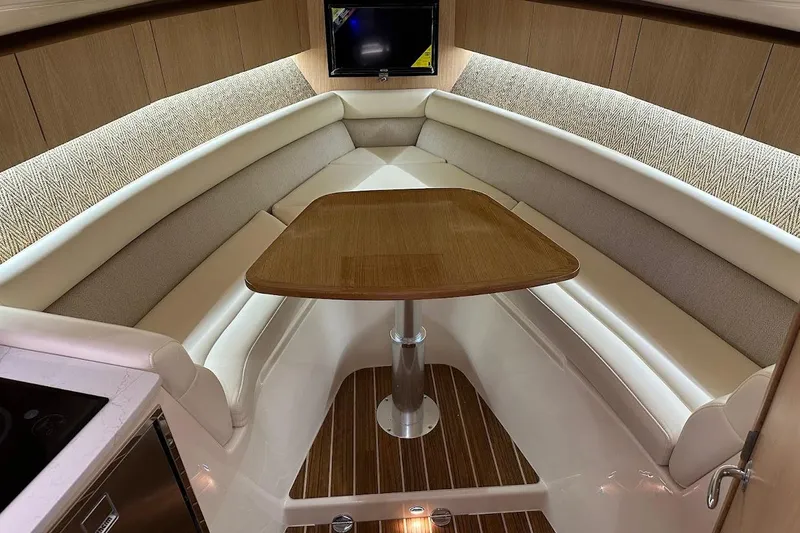 Slide: The Image of Luxurious interior of 2026 Grady-White Express 340 boat with elegant seating and wooden table. - 22