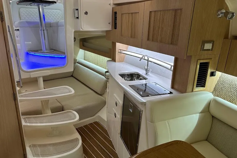 Slide: The Image of Luxurious interior of 2026 Grady-White Express 340 boat with modern kitchen and seating area. - 25