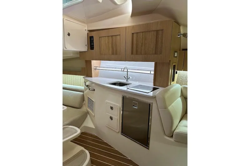 Slide: The Image of 2026 Grady-White Express 340 interior with modern kitchen and seating area. - 26