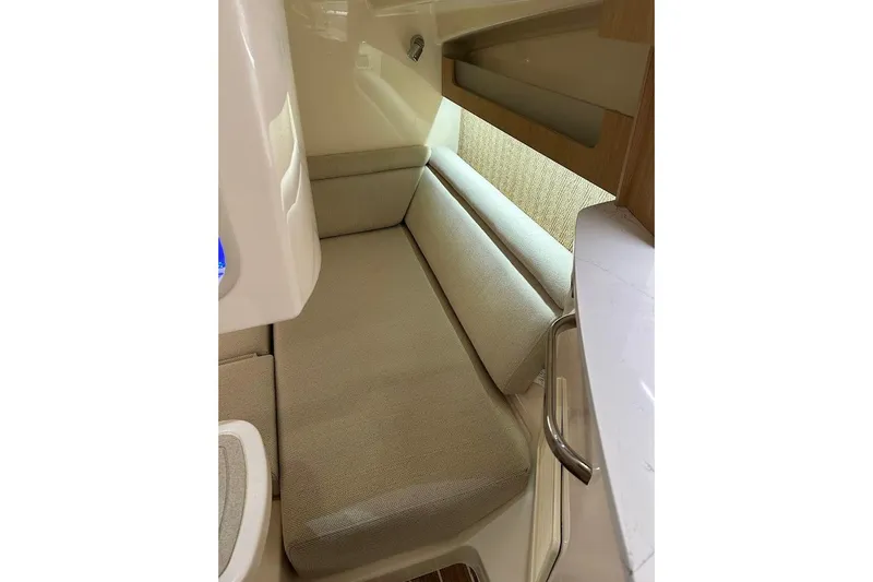 Slide: The Image of 2026 Grady-White Express 340 interior cabin with beige seating and modern design. - 30