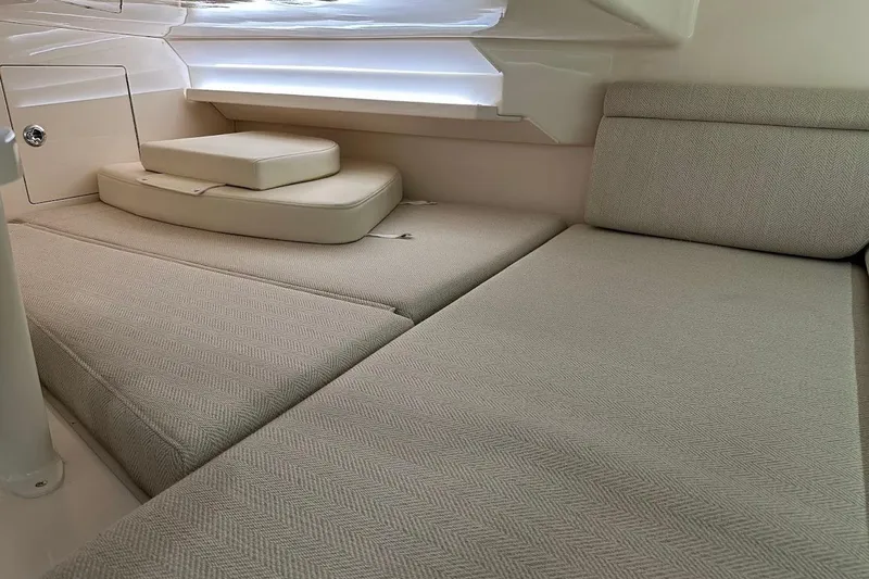 Slide: The Image of 2026 Grady-White Express 340 cabin interior with beige cushioned seating. - 31