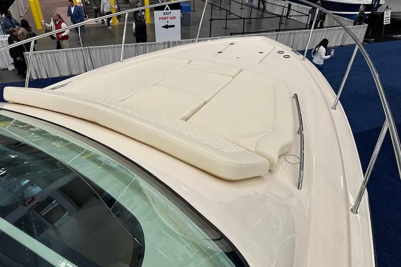 Slide: The Image of 2026 Grady-White Express 340 boat deck with cushioned seating at a boat show. - 33