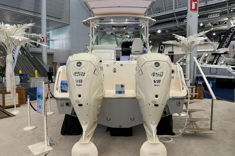 Slide: The Image of 2026 Grady-White Express 340 boat with dual 450 V8 engines displayed indoors. - 5