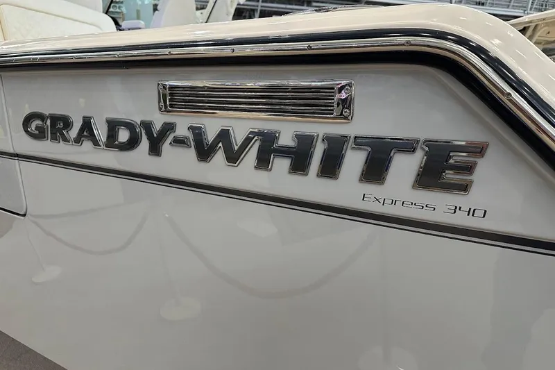 Slide: The Image of 2026 Grady-White Express 340 boat logo on sleek white exterior. - 6