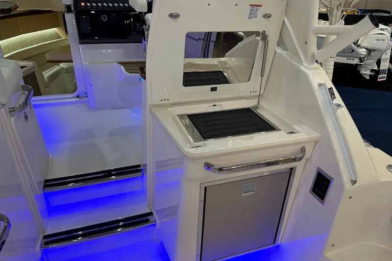 Slide: The Image of 2026 Grady-White Express 340 boat interior with illuminated steps and modern amenities. - 9