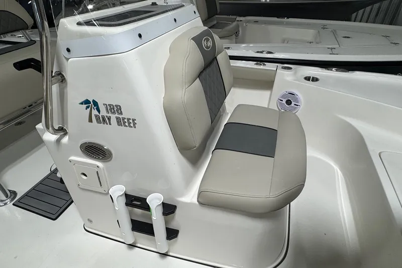 Slide: The Image of 2026 Key West 188 Bay Reef boat interior with cushioned seating and console details. - 8