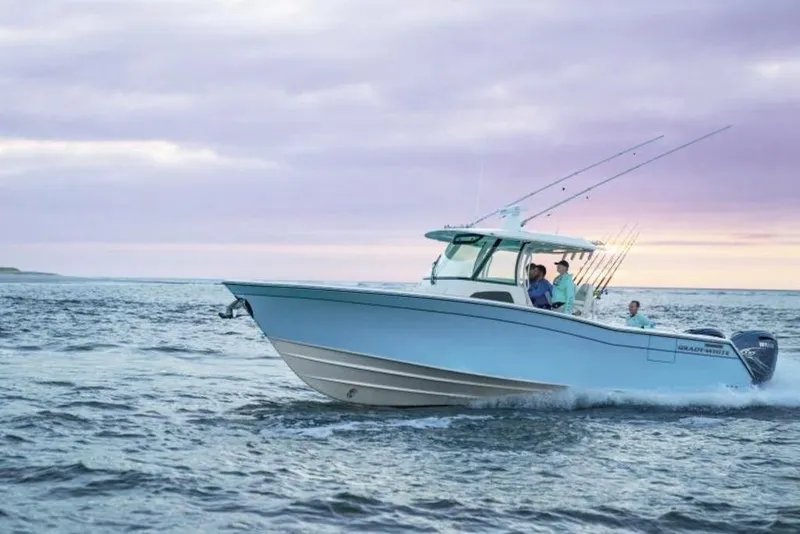 The Image of 2026 Grady-White Canyon 336 boat cruising on open water at sunset. - 1